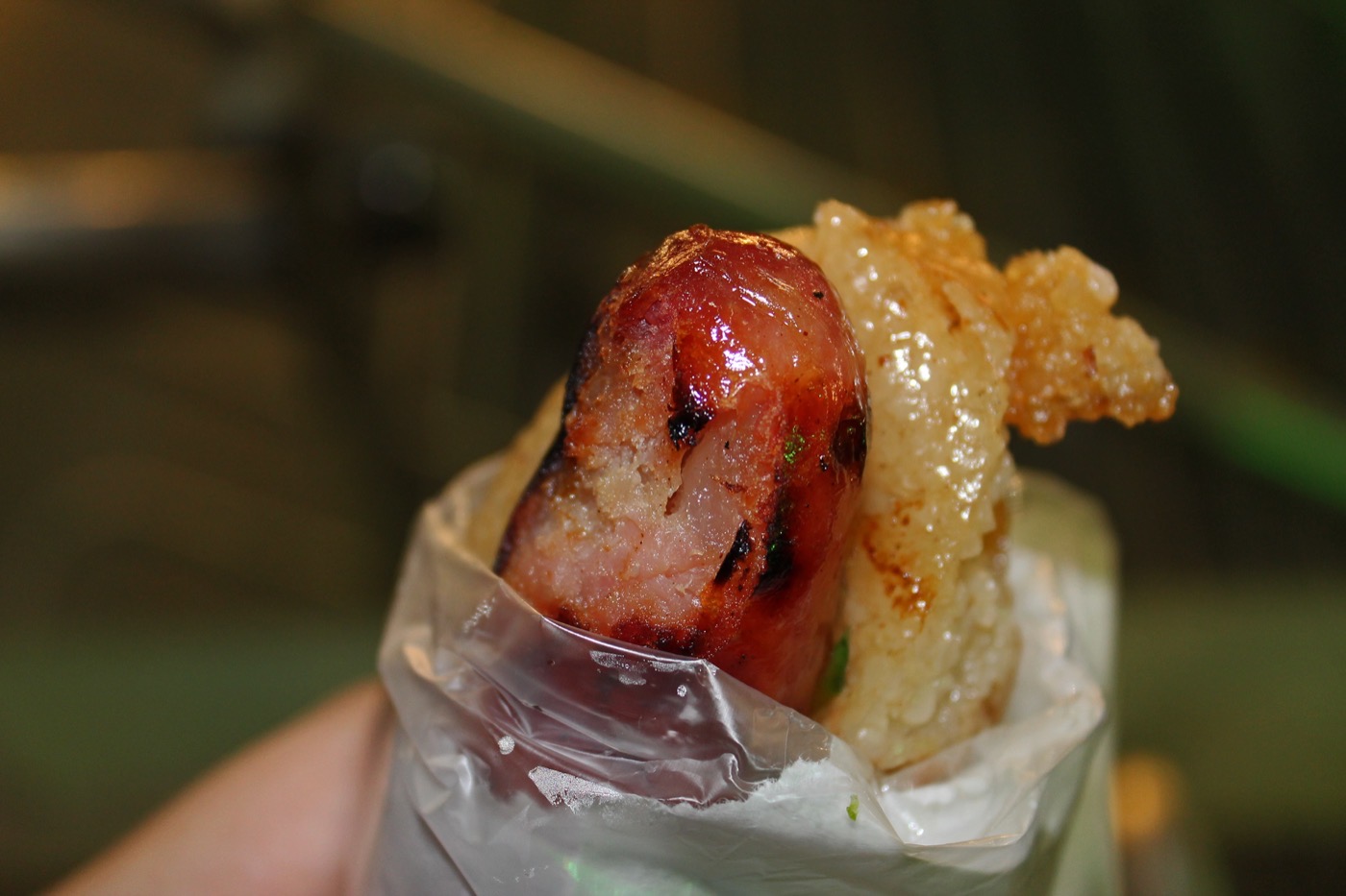 Taiwanese sausage rice roll (大腸包小腸) — a grilled sausage wrapped in a split glutinous rice log with pickled vegetables
